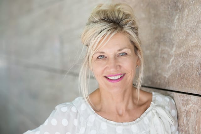 Middle aged woman smiling.