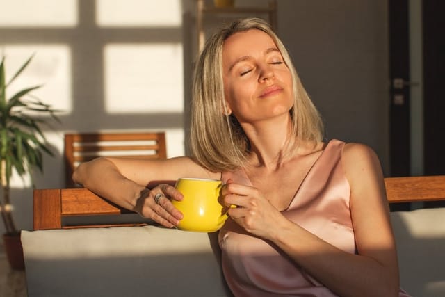 Woman enjoying her morning coffee.
