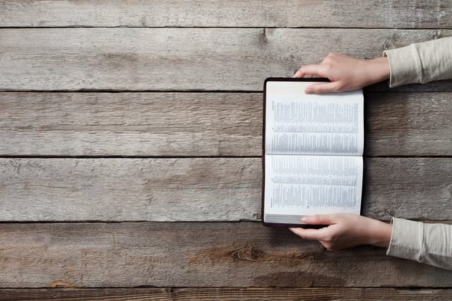 Woman's hands on a bible.