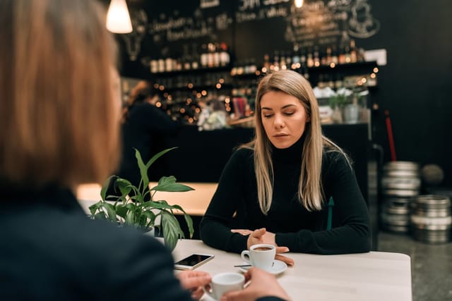 Two friends in a cafe.