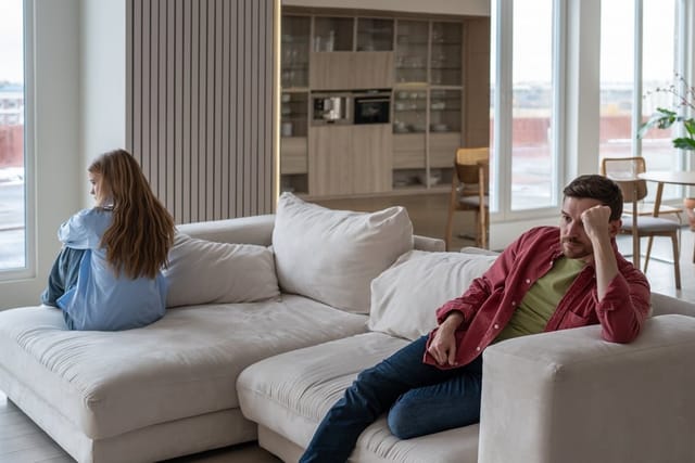 Man and woman fighting on the couch.