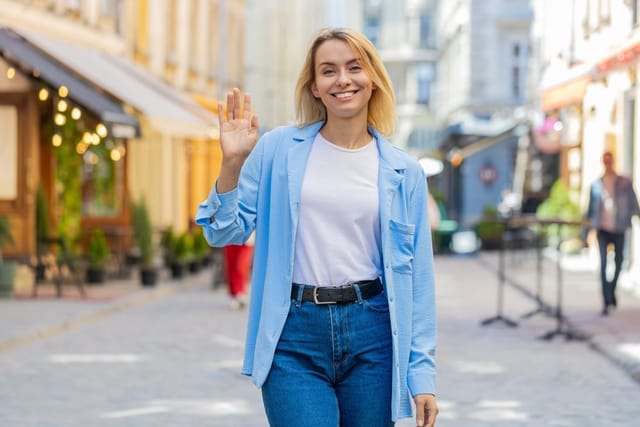 Woman waving goodbye.