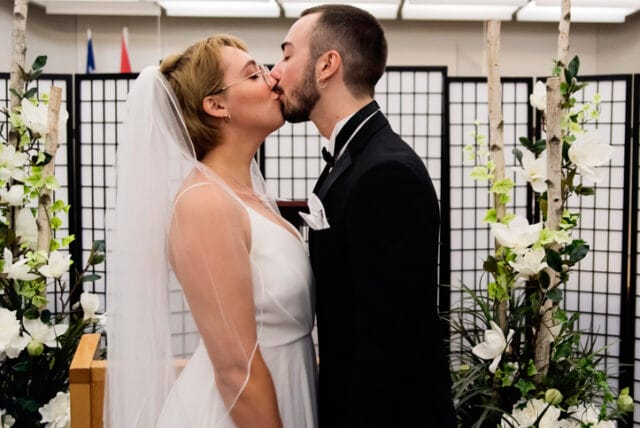 couple kissing after courthouse wedding