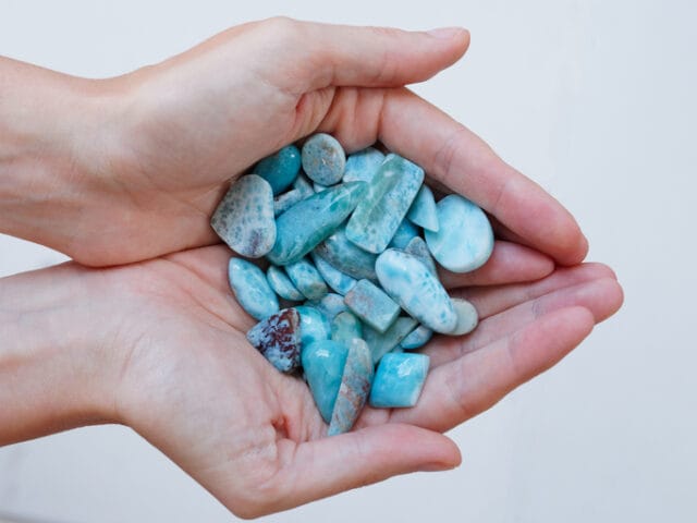 polished larimar stones in palm
