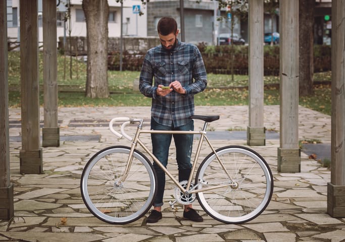 hipster man with bike on phone