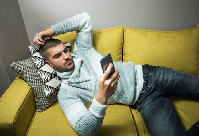 Young man surfing the internt from phone