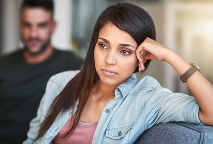 Shot of a young woman looking upset after having a fight with her partner at home