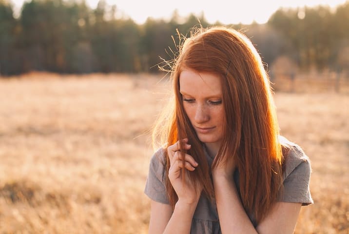 young redhead woman field portrait