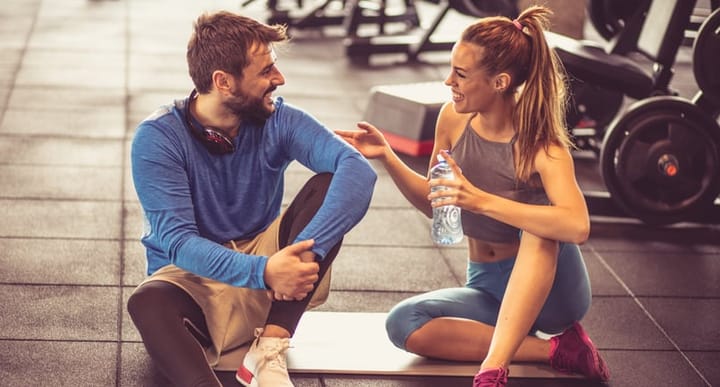 man and woman flirting at the gym