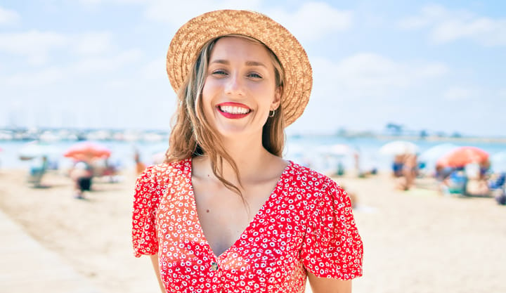 girl smiling beach red dress