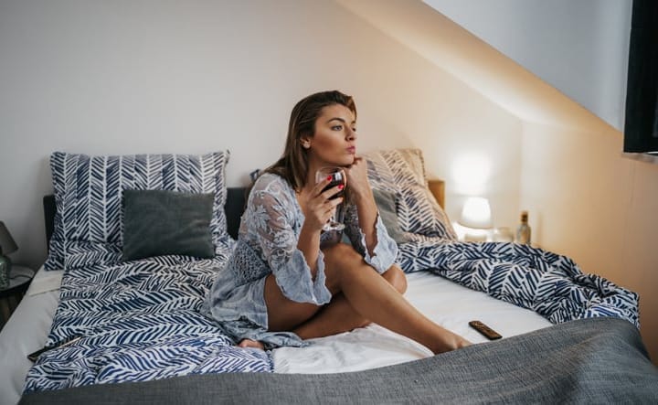 woman sitting on the bed alone