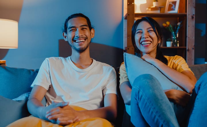 couple watching TV on couch