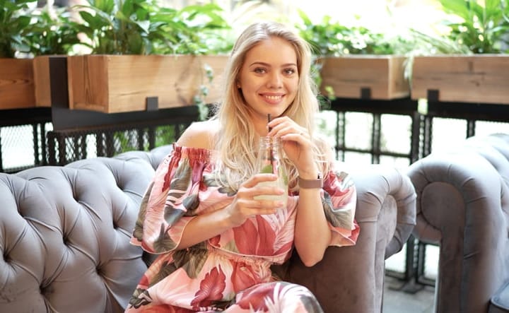 woman sitting sipping on a drink