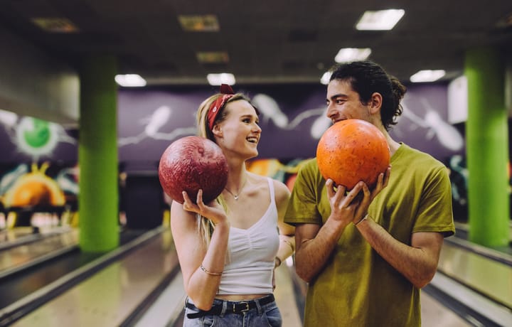 young couple on a date bowling