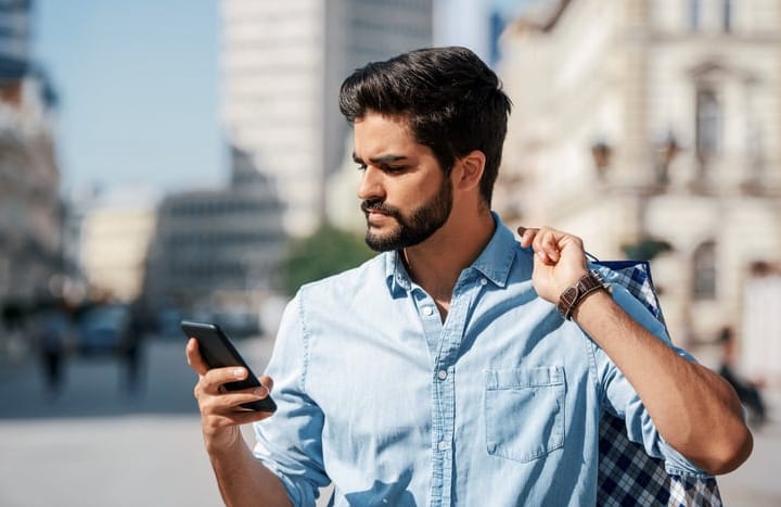 bearded man texting someone online