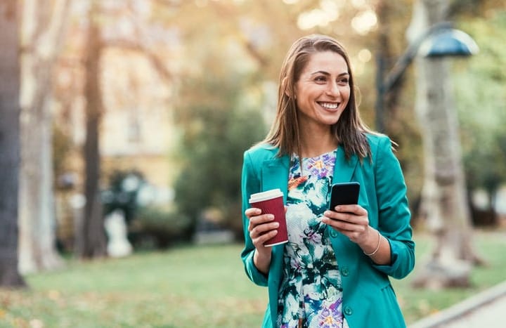 Young woman on her phone in the park.
