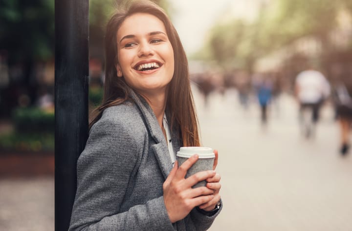 Woman drinking coffee outdoor in the city.