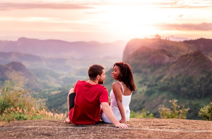 couple sitting on mountaintop