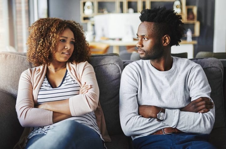 young black couple arms crossed