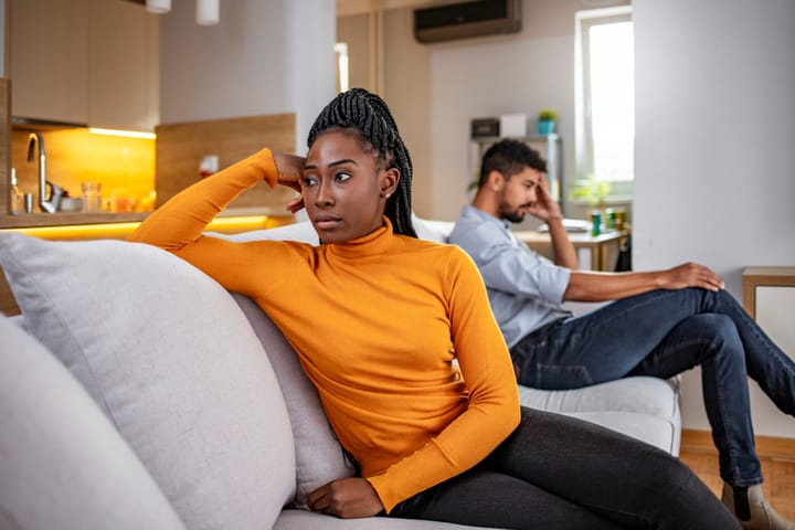 frustrated woman looking away from boyfriend
