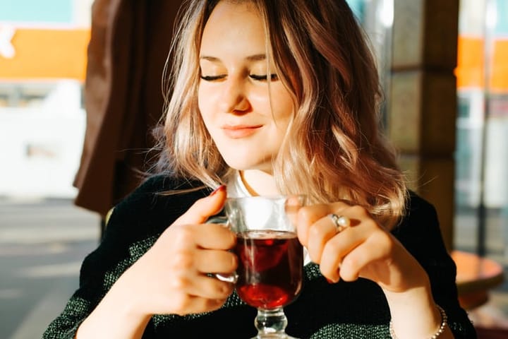 smiling woman drinking tea