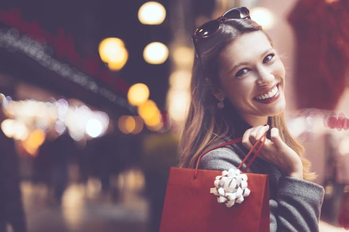 Attractive woman smiling with shopping