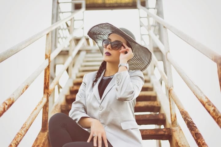 Elegant woman in floppy hat on steps