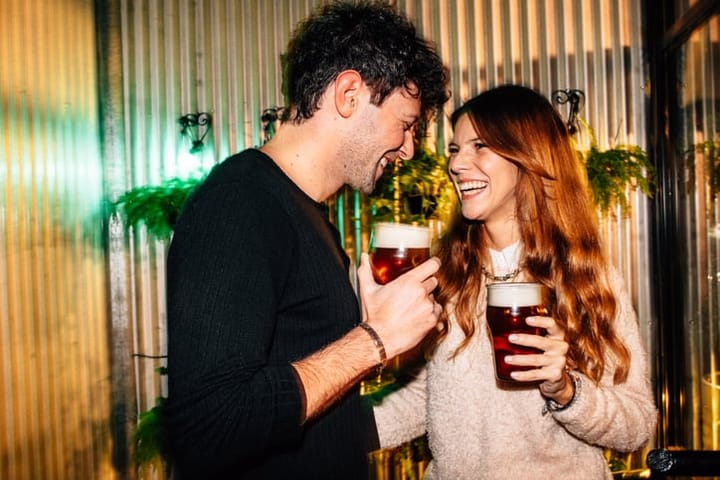 man and woman drinking beer