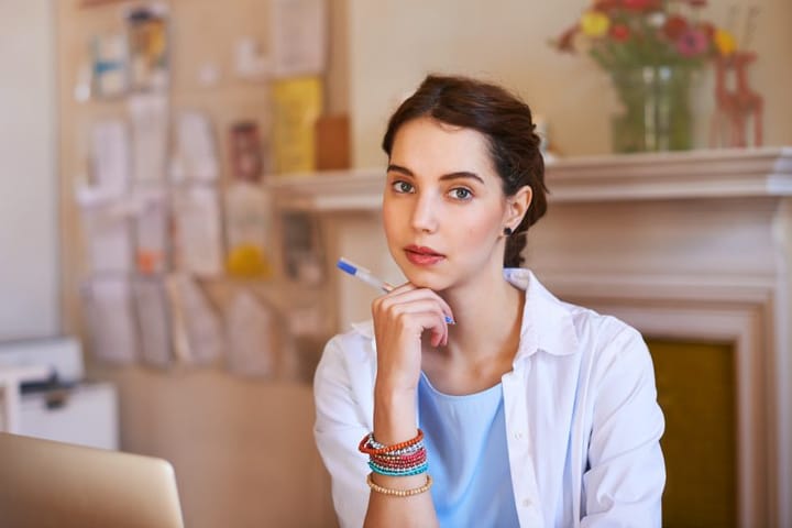 Woman sat at table confident