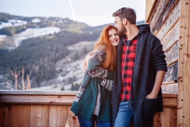 couple embracing at winter ski lodge