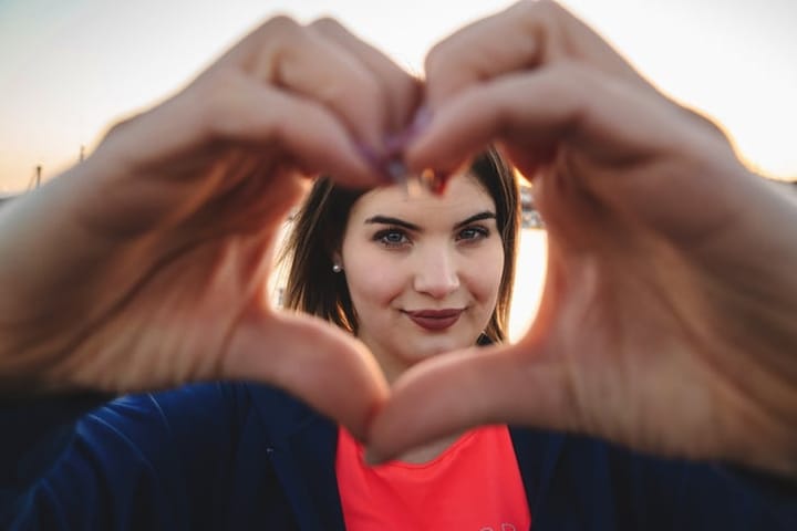 woman making the heart shape with hands