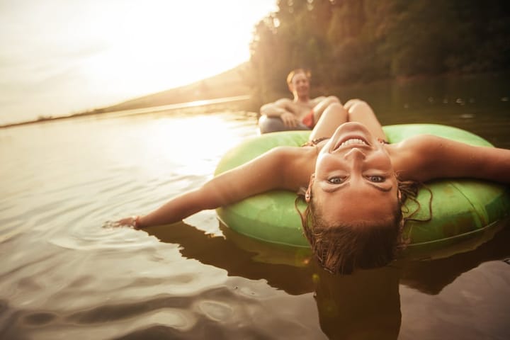 woman boyfriend lake tubing outdoors summer