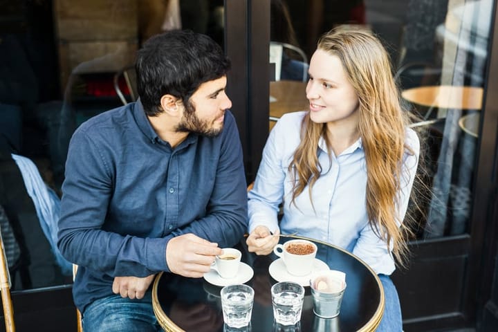 Young Couple Drinking Coffee Together in an Outdoors Cafeteria