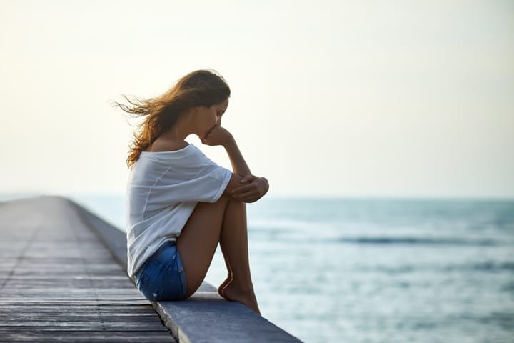 woman sad water pier outdoors