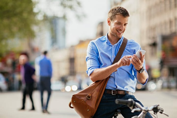 man texting on his bike