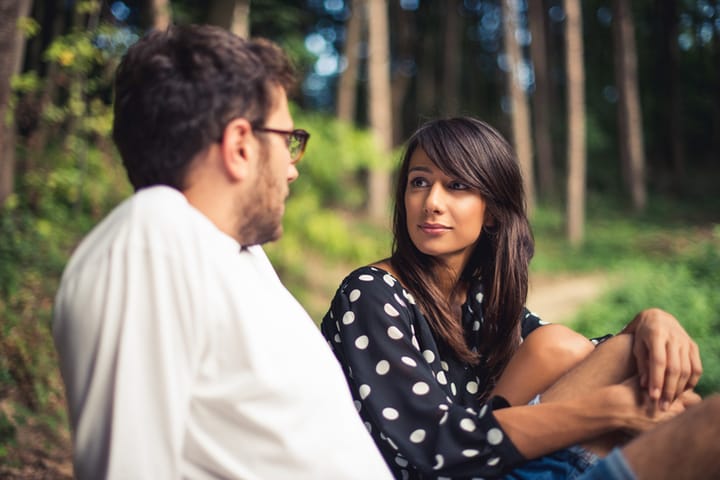 couple talking forest outdoors happy