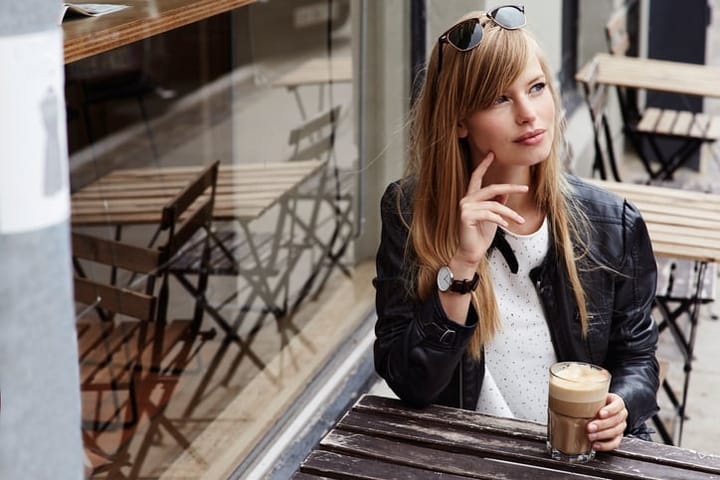 Beautiful young woman taking a break with coffee