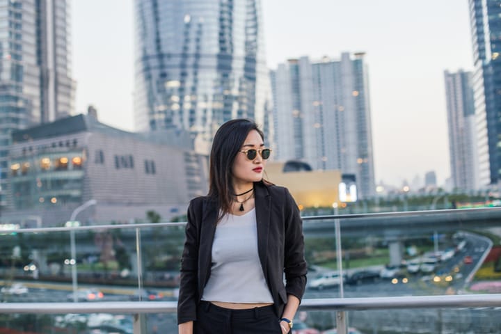 Beautiful businesswoman enjoying the sunny day outside of the office, in downtown.