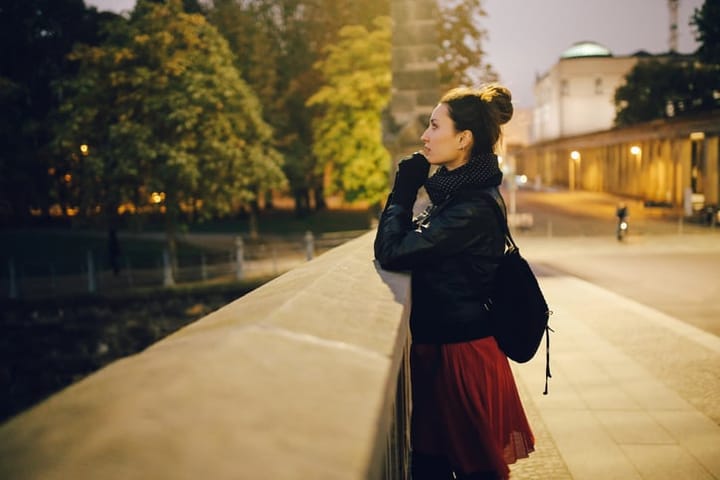 Young woman walking and relaxing in Berlin Mitte at night