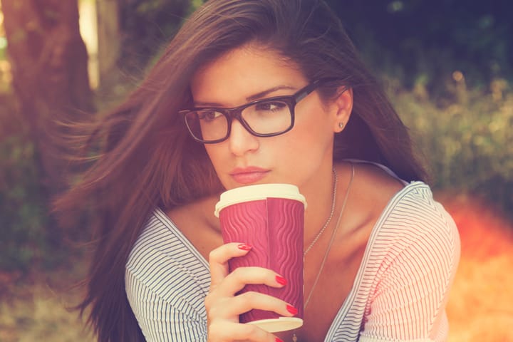 Portrait of brunette with mug in hands.