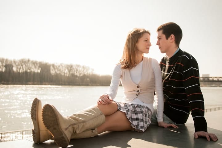 Young happy couple looking on each other - outdoor lifestyle portrait