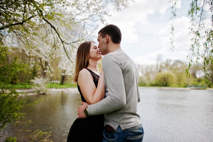 Young couple in love outdoor. Boy kiss nose of his girl