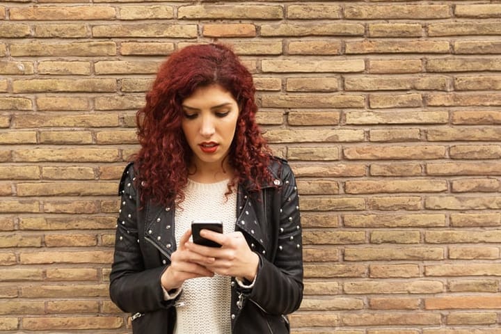 Beautiful woman text messaging