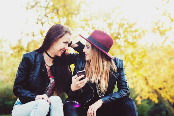 Smiling girl with a mobile phone