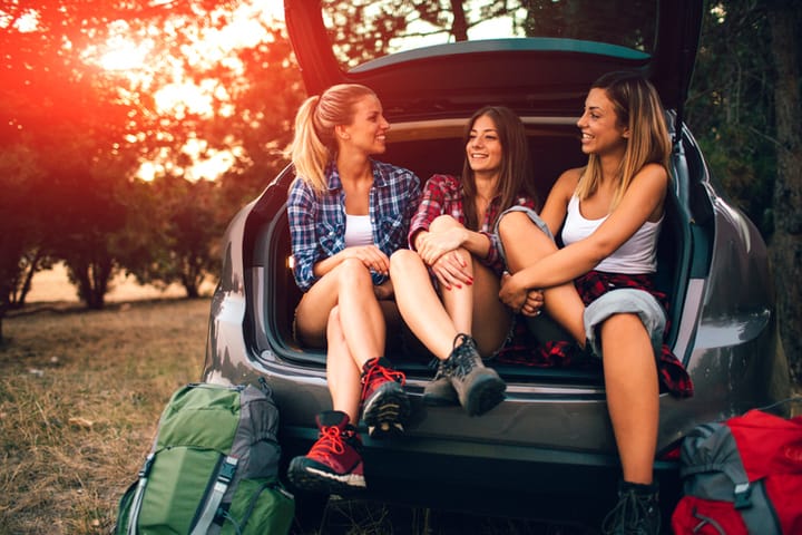Young Women Preparing For Hike and Camping In Forest.