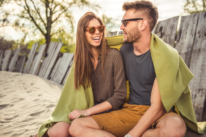 Young couple in love enjoying their relationship on the beach.