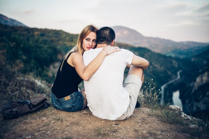 Couple resting on mountain