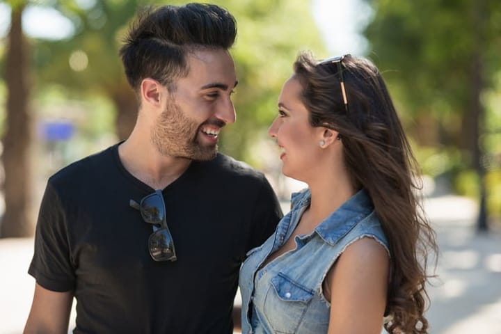 Profile portrait of happy couple in love looking at each other