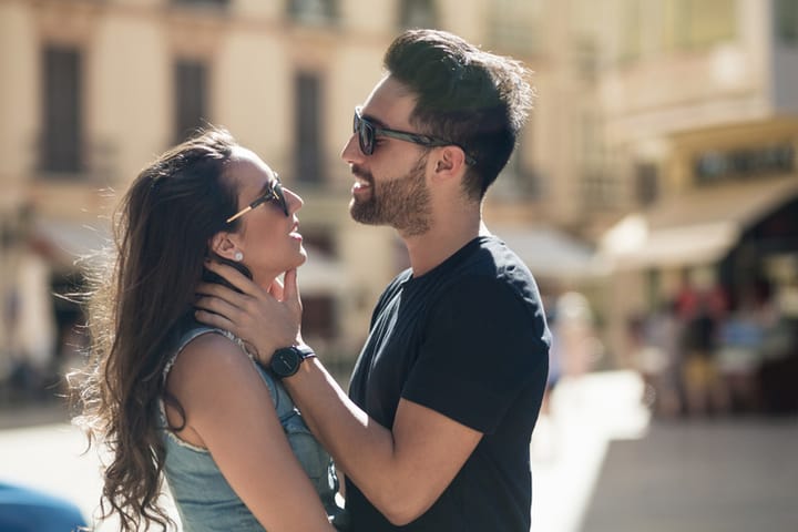 Side portrait of young man touching his girlfriend tenderly