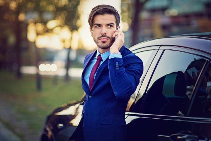 Young businessman is talking using his mobile phone